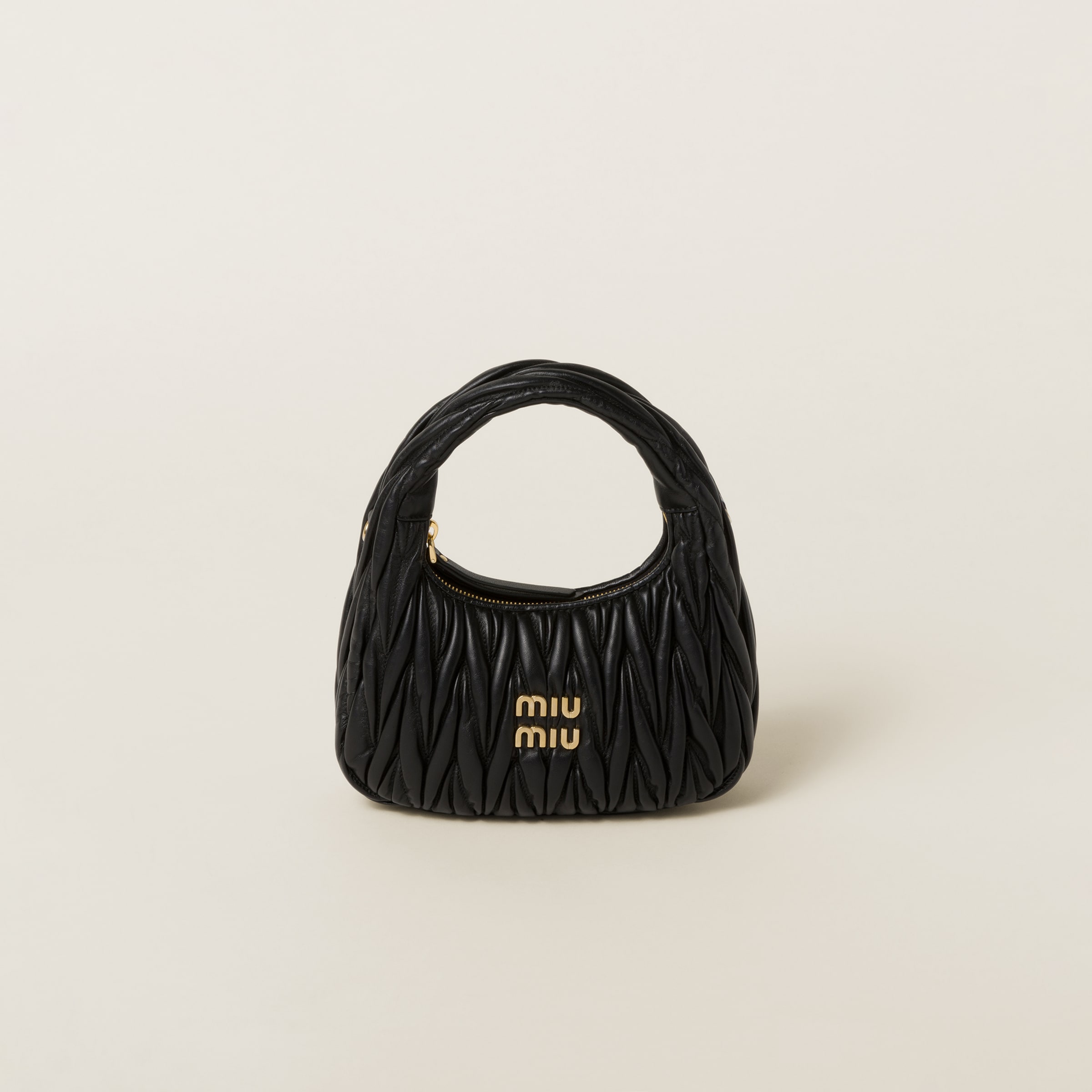 Miu Miu bag on a light background
